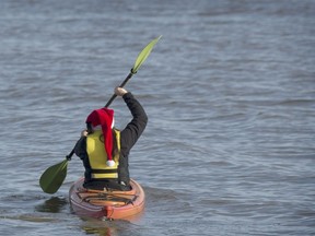 A woman kayaks on the Lake of Two Mountains near Montreal on Sunday.