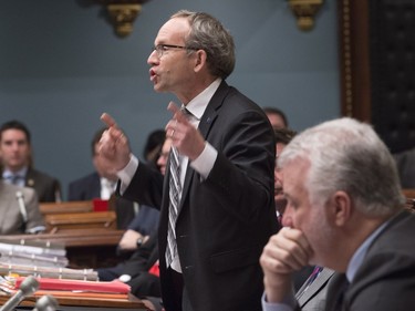 Quebec Treasury board president Martin Coiteux responds to the Opposition, during question period Thursday, November 12, 2015 at the legislature in Quebec City. Quebec Premier Philippe Couillard, right, looks on.