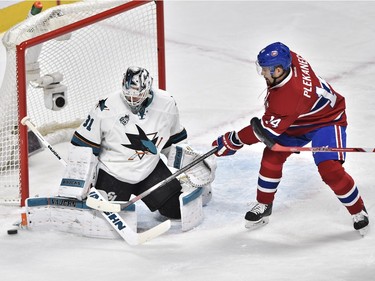 San Jose Sharks' goalie Martin Jones (31) stops Montreal Canadiens' centre Tomas Plekanec (14) during first period NHL action, in Montreal, on Tuesday, Dec. 15, 2015.