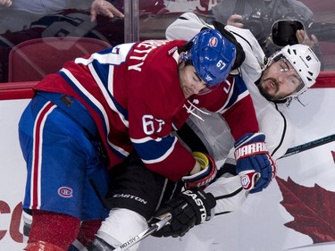 Los Angeles Kings' Drew Doughty (8) is checked into the boards by Montreal Canadiens' Max Pacioretty (67) during third period NHL hockey action, in Montreal, on Thursday, Dec. 17, 2015.
