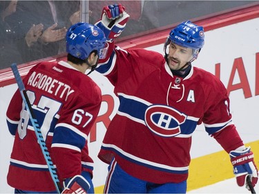 Montreal Canadiens' captain Max Pacioretty (67) celebrates with teammate Tomas Plekanec after scoring on the Ottawa Senators during first period NHL hockey action, in Montreal, on Saturday, Dec. 12, 2015.