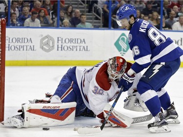 Montreal Canadiens goalie Mike Condon (39) makes a pad save on a shot by Tampa Bay Lightning right wing Nikita Kucherov (86), of Russia, during the second period of an NHL hockey game Monday, Dec. 28, 2015, in Tampa, Fla.