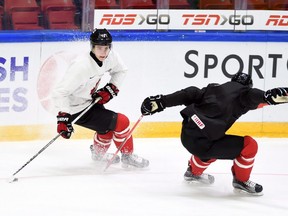 Canada's Mitchell Marner, left, skates the puck past Travis Konecny during practice in Helsinki, Finland on Friday, Dec. 25, 2015, prior to the start of the IIHF World Junior Championship on Dec 26. Canada will face the United States in their first game of the championship.