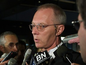 File photo: Then federal prosecutor James Brunton (now a Superior Court judge) speaking in a press scrum at the Montreal courthouse on June 25, 2002.