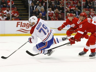 Montreal Canadiens defenceman Andrei Markov (79) shoots as Detroit Red Wings defenceman Niklas Kronwall (55) defends in the first period of an NHL hockey game Thursday, Dec. 10, 2015 in Detroit.