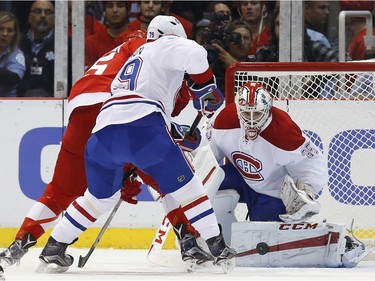 Montreal Canadiens goalie Dustin Tokarski (35) stops a Detroit Red Wings shot in the first period of an NHL hockey game Thursday, Dec. 10, 2015 in Detroit.