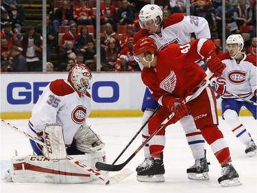Canadiens goalie Dustin Tokarski (35) stops a shot by Detroit Red Wings centre Luke Glendening (41) as Jeff Petry defends in the second period of an NHL hockey game Thursday, Dec. 10, 2015 in Detroit.