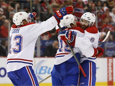 Montreal Canadiens left wing Tomas Fleischmann (15) celebrates his goal against the Detroit Red Wings with Greg Pateryn (6) and Daniel Carr (43) in the third period of an NHL hockey game Thursday, Dec. 10, 2015 in Detroit.