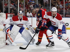 Canadiens' Andrei Markov, right, defends against Panthers' Jaromir Jagr in front of Ben Scrivens at the BB&T Center on December 29, 2015 in Sunrise, Florida.