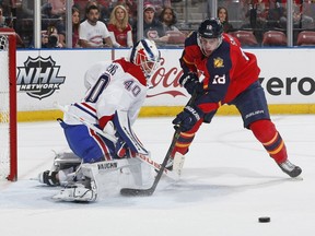 Canadiens' Ben Scrivens deflects the shot by Panthers' Reilly Smith during first period action at the BB&T Center on December 29, 2015 in Sunrise, Florida.