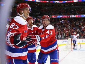 Tom Wilson #43 of the Washington Capitals and Jason Chimera #25 congratulate Jay Beagle #83 after he scored against the Montreal Canadiens during the second period at Verizon Center on Dec. 26, 2015 in Washington, DC.