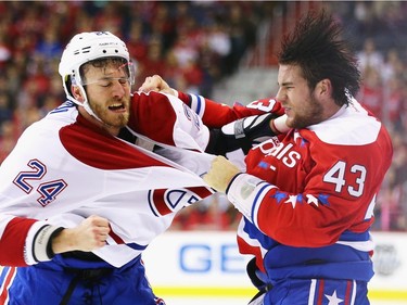 Jarred Tinordi #24 of the Montreal Canadiens and Tom Wilson #43 of the Washington Capitals exchange punches during the first period at Verizon Center on December 26, 2015 in Washington, DC.