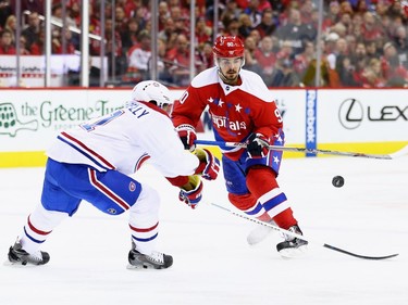 Devante Smith-Pelly #21 of the Montreal Canadiens defends Marcus Johansson #90 of the Washington Capitals during the second period at Verizon Center on December 26, 2015 in Washington, DC.