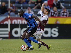 Hassoun Camara is fouled by Jose Mari of the Colorado Rapids during action at Dick's Sporting Goods Park on May 24, 2014 in Commerce City, Colorado.