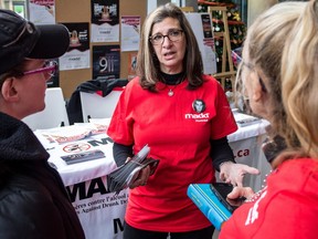 National President of Madd Canada, Angeliki Souranis, centre, talks to a student and a Madd volunteer in the EV atrium of Concordia University on Friday December 4, 2015, in Montreal.