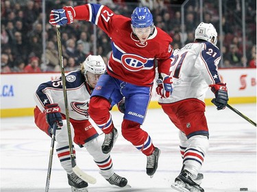 Montreal Canadiens Alex Galchenyuk hops between Columbus Blue Jackets William Karlsson, left and Kerby Rychel during first period of National Hockey League game in Montreal Tuesday December 1, 2015.