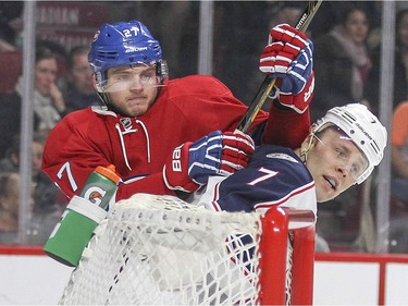 Montreal Canadiens Alex Galchenyuk, left, jostles with Columbus Blue Jackets  Jack Johnson during first period of National Hockey League game in Montreal Tuesday December 1, 2015.