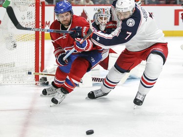 Montreal Canadiens David Desharnais, left, fights for loose puck with Columbus Blue Jackets Jack Johnson during first period of National Hockey League game in Montreal Tuesday December 1, 2015. Blue Jackets goalie Sergei Bobrovsky watches from the net.
