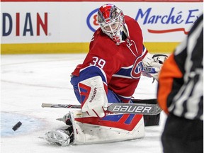 Montreal Canadiens goalie Mike Condon directs the puck toward the corner  during second period of National Hockey League game against the Columbus Blue Jackets in Montreal Tuesday December 1, 2015.