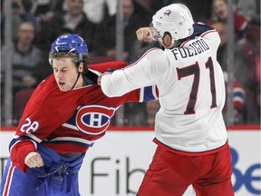 Montreal Canadiens Nathan Beaulieu, left, fights with Columbus Blue Jackets Nick Foligno during National Hockey League game in Montreal Tuesday December 1, 2015.