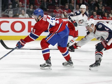Montreal Canadiens Paul Byron shoots the puck at the Columbus Blue Jackets net for the first goal of the game despite backcheck by Jackets Kevin Connauton during first period of National Hockey League game in Montreal Tuesday December 1, 2015.