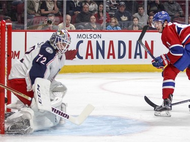 Montreal Canadiens Paul Byron shoots the puck past Columbus Blue Jackets goalie Sergei Bobrosvky for the first goal of the game despite backcheck by Jackets Kevin Connauton during first period of National Hockey League game in Montreal Tuesday December 1, 2015.