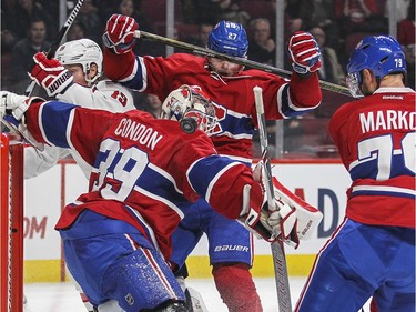 Montreal Canadiens Andrei Markov and Alex Galchenyuk watch as Washington Capitals T.J. Oshie's shot bounces behind goalie Mike Condon for a goal during second period of National Hockey League game in Montreal Thursday December 3, 2015. Being shoved out of the way by Galchenyuk is Capitals Nicklas Backstrom.