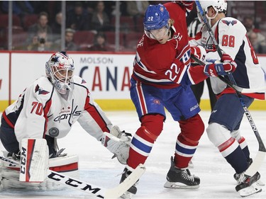 Montreal Canadiens Dale Weise looks for rebound of save by Washington Capitals goalie Braden Holtby while being tied up by Capitals defenceman Nate Schmidt during National Hockey League game in Montreal Thursday December 3, 2015.