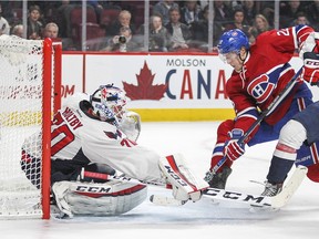 Montreal Canadiens Dale Weise is tied up by Washington Capitals Nate Schmidt as he drives to the net in front of goalie Braden Holtby during National Hockey League game in Montreal Thursday December 3, 2015.