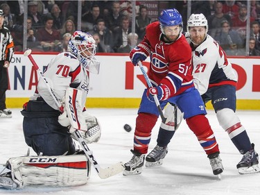 Montreal Canadiens David Desharnais tries to deflect shot in front of Washington Capitals goalie Braden Holtby and defenceman Karl Alzner during third period of National Hockey League game in Montreal Thursday December 3, 2015.
