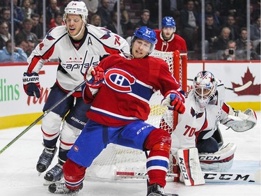 Montreal Canadiens Lars Eller is knocked off stride by Washington Capitals John Cartlson during National Hockey League game in Montreal Thursday December 3, 2015. Carlson was penalized on the play.