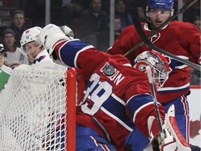 Washington Capitals Nicklas Backstrom, left, watches as shot by team-mate T.J. Oshie rolls down Montreal Canadiens goalie Mike Condon's back and into the net for the Capitals second goal of the game during National Hockey League game in Montreal Thursday December 3, 2015. Canadoens Alex Galchenyuk watches at right.