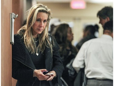 Bettina Rizzutto  waits in the hall at the Palais de Justice at bail hearing for Loris Cavaliere, lawyer who was arrested in recent roundup of organized crime figures in Montreal Friday December 04, 2015.  Bettina Rizzutto is the daughter of Vito Rizzutto, the deceased former head of the Montreal mafia.  She works in Cavaliere's law firm.
