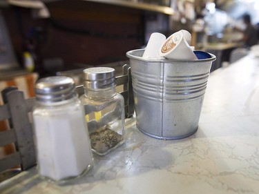 Cream and milk bucket next to salt and pepper shaker at Moe's-Casse-Croute-du-Coin Friday, December 4, 2015.