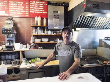 Eddy Thomas behind next to the grill at Moe's-Casse-Croute-du-Coin Friday, December 4, 2015.