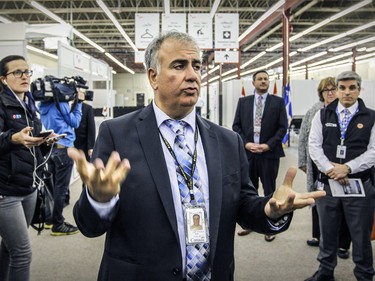 Vito Vassallo, Director of Operations for the Eastern Region for Immigration, Refugees and Citizenship Canada,  leads journalists on a tour of the welcome centre in the St. Laurent borough for refugees arriving in Canada, in Montreal Tuesday December 8, 2015.