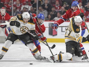 Boston Bruins Brad Marchand, left and Patrice Bergeron battle for the puck with Montreal Canadiens Sven Andrighetto and Alex Galchenyuk, right during first period of National Hockey League game in Montreal Wednesday December 9, 2015.