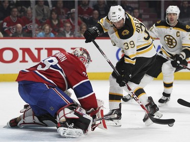 Boston Bruins Matt Belesky can't control bouncing puck in front of Montreal Canadiens goalie Mike Condon as Bruins Zdeno Chara trails the play during second period of National Hockey League game in Montreal Wednesday December 9, 2015.