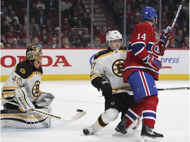 Boston Bruins Tuuka Rask makes a save as teammate Torey Krug ties up Montreal Canadiens Tomas Plekanec during third period of National Hockey League game in Montreal Wednesday December 9, 2015.