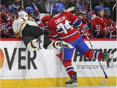 Montreal Canadiens Alexei Emelin checks Boston Bruins Brett Connolly into the boards during first period of National Hockey League game in Montreal Wednesday December 9, 2015.