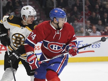 Montreal Canadiens Alexei Emelin tries to bat the puck in front of Boston Bruins  Loui Eriksson during second period of National Hockey League game in Montreal Wednesday December 9, 2015.