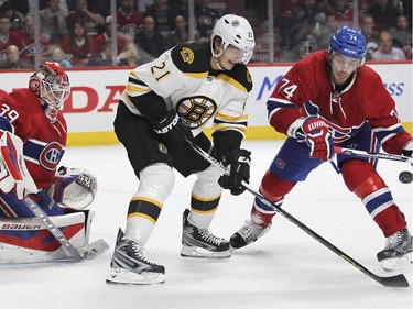 Montreal Canadiens Alexei Emelin, right, competes for loose puck with Boston Bruins Loui Eriksson in front of Habs goalie Mike Condon during second period of National Hockey League game in Montreal Wednesday December 9, 2015.