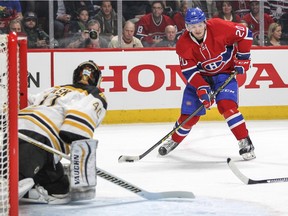 The Canadiens' Christian Thomas looks to pass the puck in front of Boston Bruins goalie Tuuka Rask during NHL game at Montreal's Bell Centre on Dec. 9, 2015.