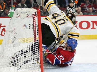 Montreal Canadiens Dale Weise crashes into Boston Bruins goalie Tuuka Rask after being tripped by Bruin Dennis Seidenberg during third period of National Hockey League game in Montreal Wednesday December 9, 2015. Seidenberg was penalized on the play.