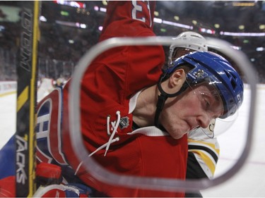 Montreal Canadiens Daniel Carr is checked into the glass by Boston Bruins Kevan Miller during first period of National Hockey League game in Montreal Wednesday December 9, 2015.