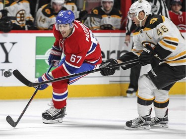 Montreal Canadiens Max Pacioretty chips the puck into the Boston Bruins zone while being pursued by David Krejci during first period of National Hockey League game in Montreal Wednesday December 9, 2015.