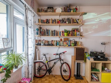 Bookshelves, antique cameras, and a wall projector decorate the main living space.  (Dario Ayala / Montreal Gazette)