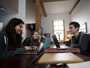 McGill University students Ingy El Kafrawy, left to right, Phoebe Colby and Anton Zyngier discuss expanding their tutoring sessions at Solin Hall in Montreal on Thursday Dec. 10, 2015. The three are part of a larger group of McGill students, under professor Anita Nowak that are tutoring Syrian refugees in Turkey via Skype.