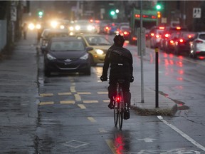 A lone cyclist makes his way east on the bike path on Rachel St. in Montreal in December.