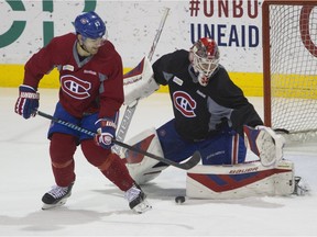 Canadiens captain Max Pacioretty tries to deflect a puck past goalie Michael Condon during practice at the Bell Sports complex in Brossard near Montreal Wednesday, December 2, 2015.